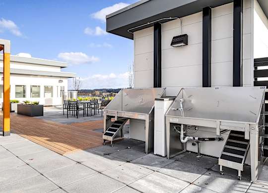 A machine is on a patio outside a building.