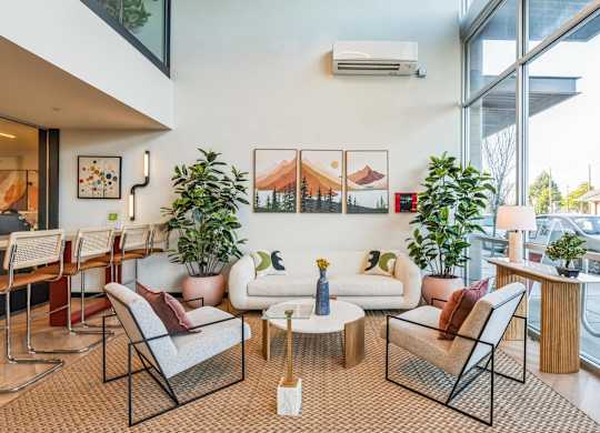 A living room with a couch, chairs, and a coffee table.