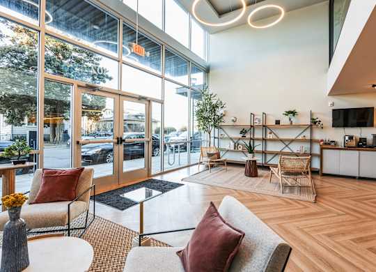 A modern living room with a couch, chairs, and a coffee table.