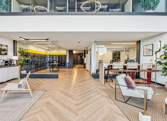 A modern living room with a wooden floor and a white sofa.