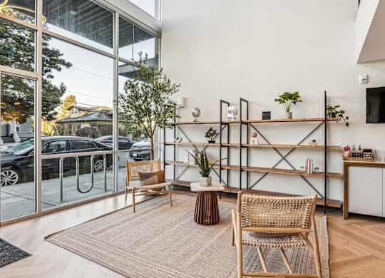 A modern living room with a glass door leading to a parking area.