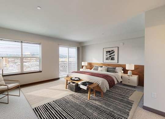 A bedroom with a bed, nightstand, and chair.