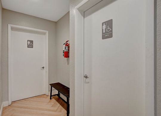A hallway with a bench and a fire extinguisher.
