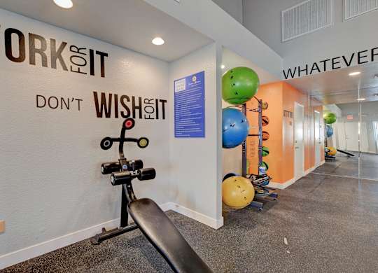A gym with a wall that says