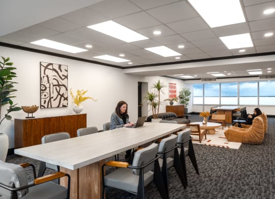 a woman sitting at a table in a conference room with a laptop at Vision on Lombard, Baltimore, MD 21201