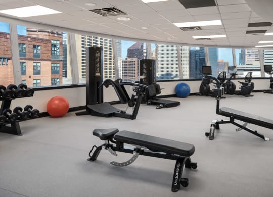 a gym with exercise equipment and a view of the city at Vision on Lombard, Baltimore, MD 21201