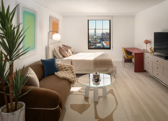 a living room with a couch and a bed in a room at Vision on Lombard, Baltimore, MD 21201