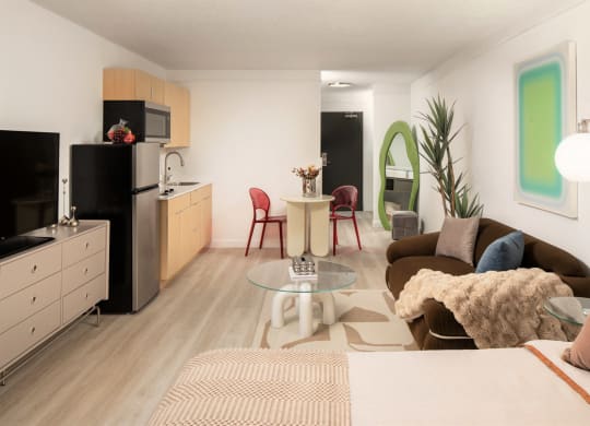 a living room and kitchen with a couch and a table at Vision on Lombard, Baltimore, MD 21201