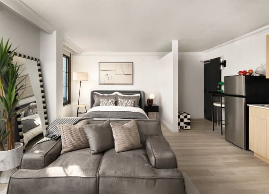 a bedroom with a couch and a bed and a kitchen at Vision on Lombard, Baltimore, MD 21201