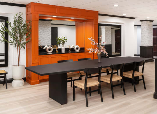 a large dining room with a black table and chairs at Vision on Lombard, Baltimore, MD 21201