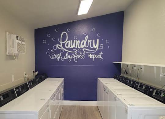 Laundry room with washers and dryers.