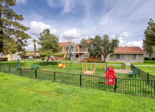 a playground with a fire hydrant in the middle of a grassy area at Valencia Park, Phoenix, Arizona, 85008