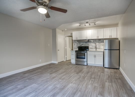 an open living room and kitchen with a ceiling fan at Valencia Park, Phoenix, Arizona