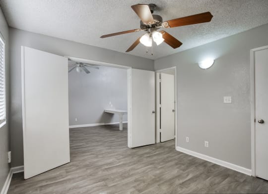 a bedroom with a ceiling fan and a closet at Valencia Park, Phoenix, AZ