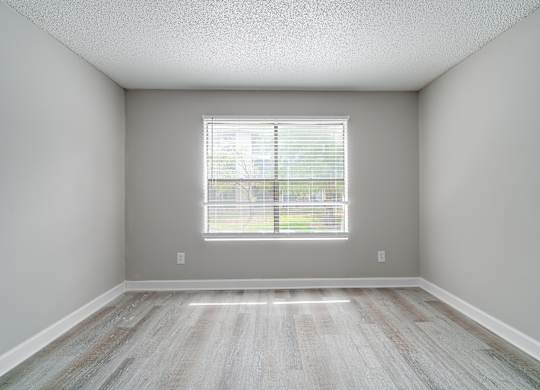 an empty room with wood floors and a window at Village Lakes, Orlando, FL, 32808