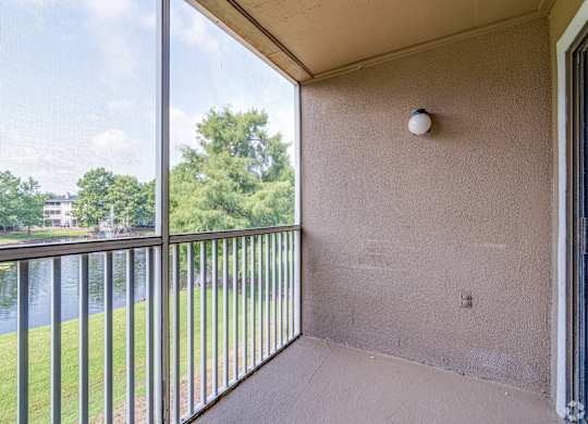 a balcony with a view of a river and trees at Village Lakes, Orlando, FL, 32808