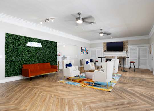 a living room with white furniture and a green wall