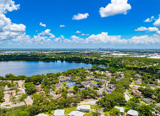 an aerial view of a neighborhood with a lake in the middle