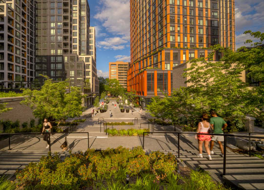 a rendering of a city street with pedestrians and trees at The Grace and Reva, Arlington, VA, 22202