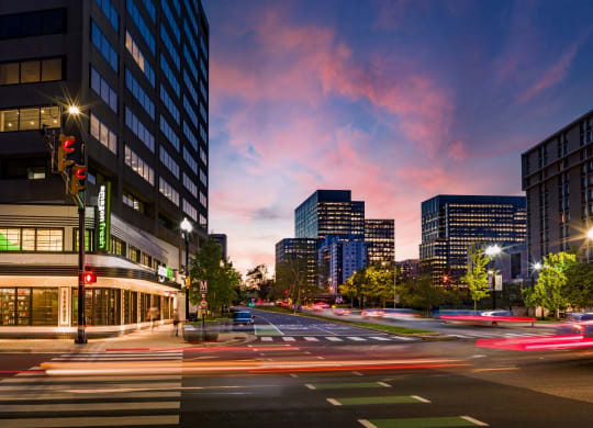 a busy city street at night with traffic and tall buildings at The Grace and Reva, Virginia, 22202