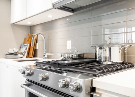 a kitchen with a stove top oven and a sink