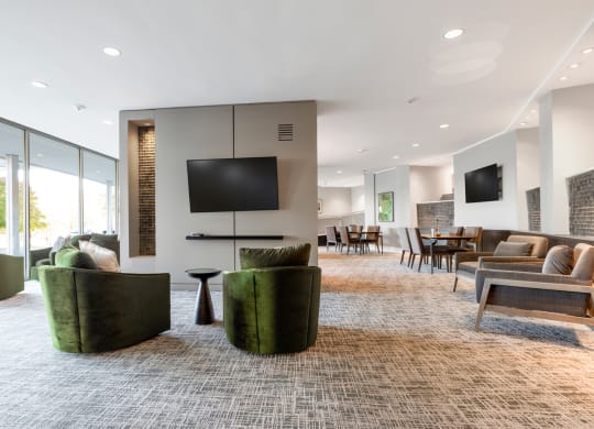 a living room with couches and chairs and a television
