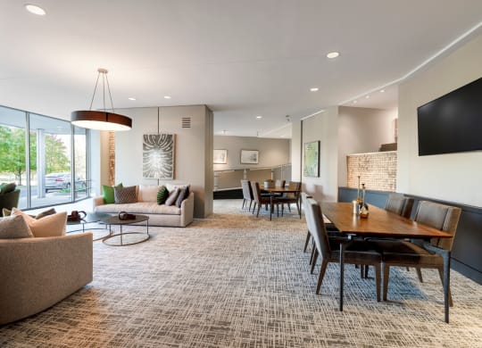 a living room and dining room with a table and chairs
