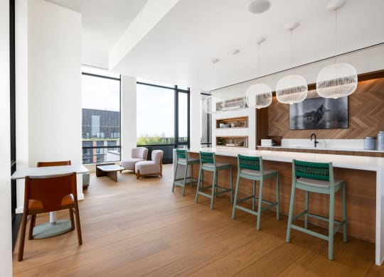 a kitchen and living room with a bar and stools at The Grace and Reva, Arlington, Virginia