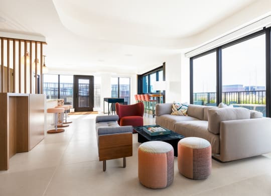 a living room filled with furniture and large windows at The Grace and Reva, Virginia, 22202