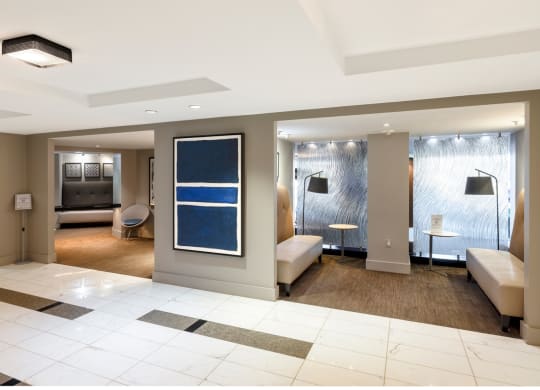 a lobby of a hotel with a reception area and a living room