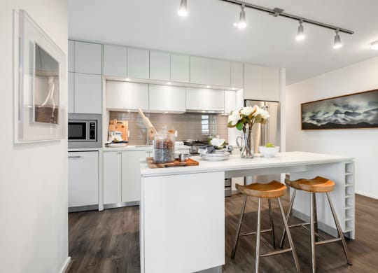 a kitchen with white cabinets and a counter top