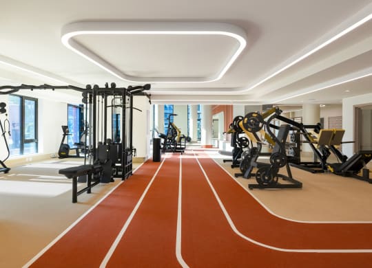 a workout room with exercise equipment and a red running track at The Grace and Reva, Virginia, 22202