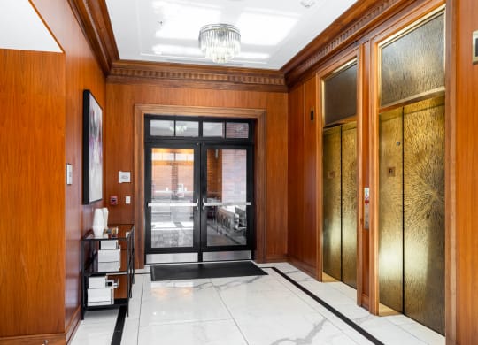 a view of a hallway with wood paneling and a glass door