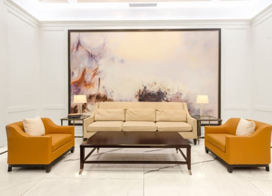 a living room with a large painting on the wall behind the couch