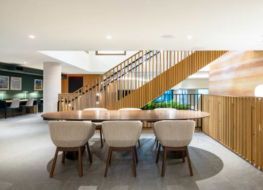 a large table and chairs in a room with a staircase at The Grace and Reva, Virginia, 22202