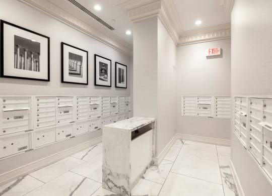 a mail room with white cabinets and a marble podium