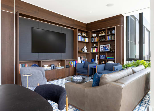a living room with a tv and a table and chairs at The Grace and Reva, Arlington, 22202