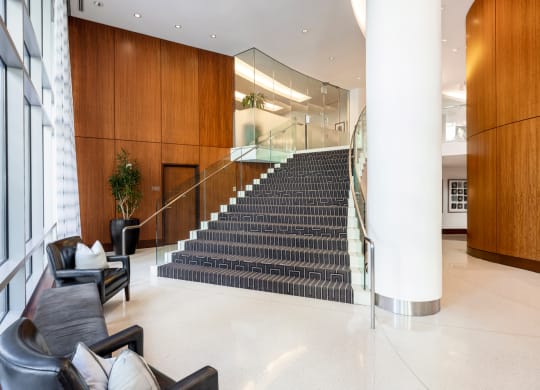 the lobby of a building with a large staircase and furniture at 220 Twentieth Street, Arlington, VA