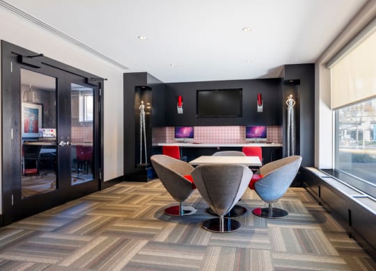 a dining room with a table and chairs and a tv on the wall