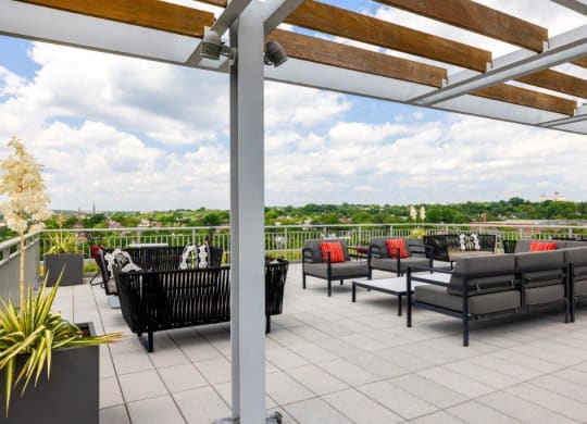 a roof deck with furniture and a view of the city