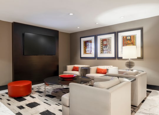 a living room with couches and a table and a television