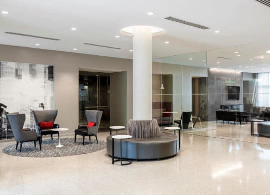 a large lobby with chairs and a table