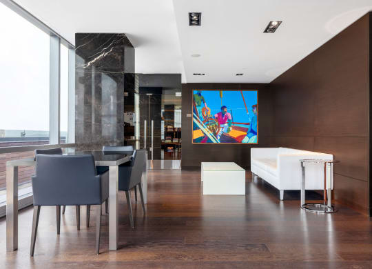 a colorful painting hangs on the wall in the dining room
