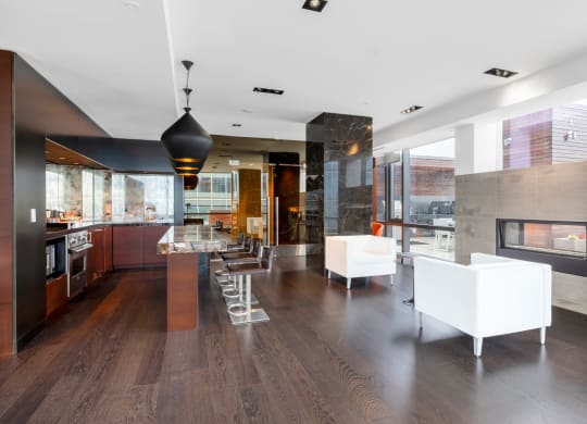 a large kitchen and living room with white furniture and a fireplace
