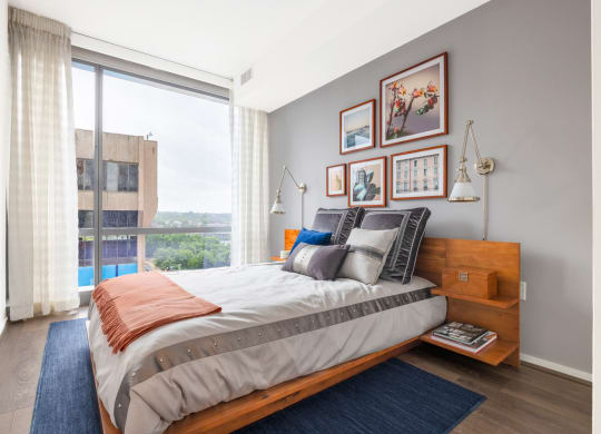 a bedroom with a bed and a large window