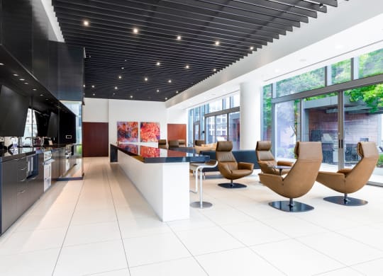 the lobby or reception area of a modern house with a bar and chairs