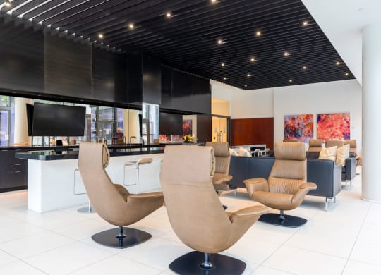 a lounge area with chairs and a bar