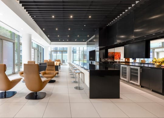 the lobby of a hotel with chairs and a bar