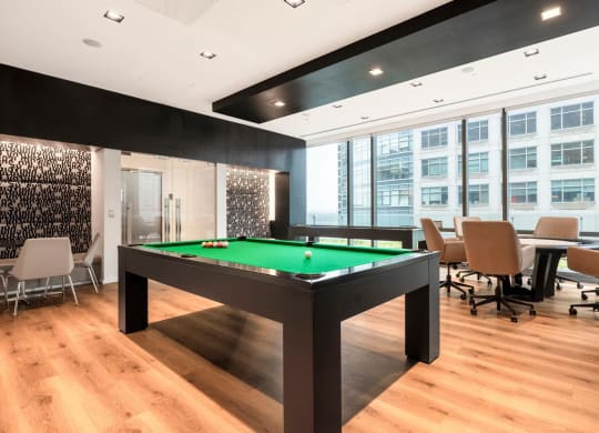 a pool table in a meeting room with chairs and tables