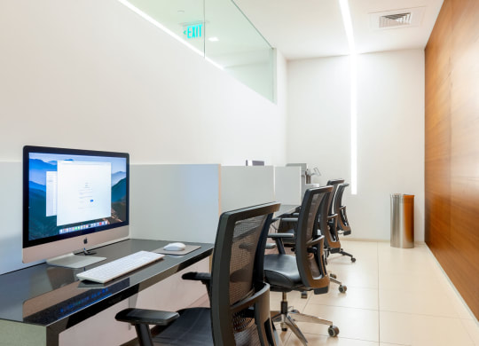 an office with a desk with a computer on it